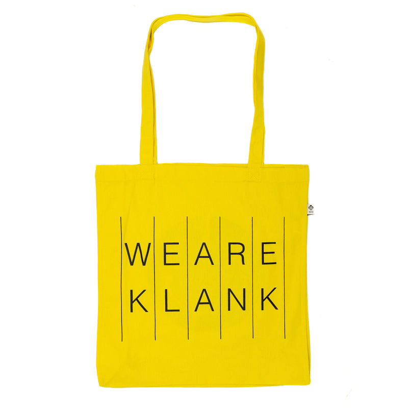 Yellow tote bag with We Are Klank lettering in black